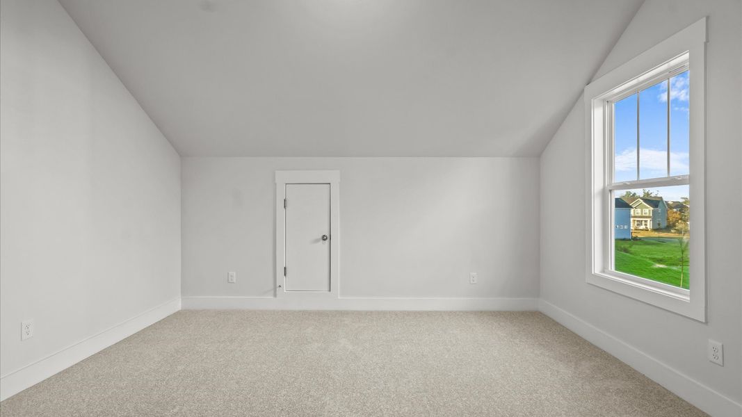 Highly functional bedroom with walk-in closet and tasteful carpet for a restful retreat