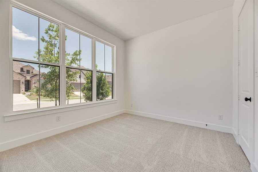 Empty room featuring light carpet and baseboards Empty room featuring light carpet and baseboards