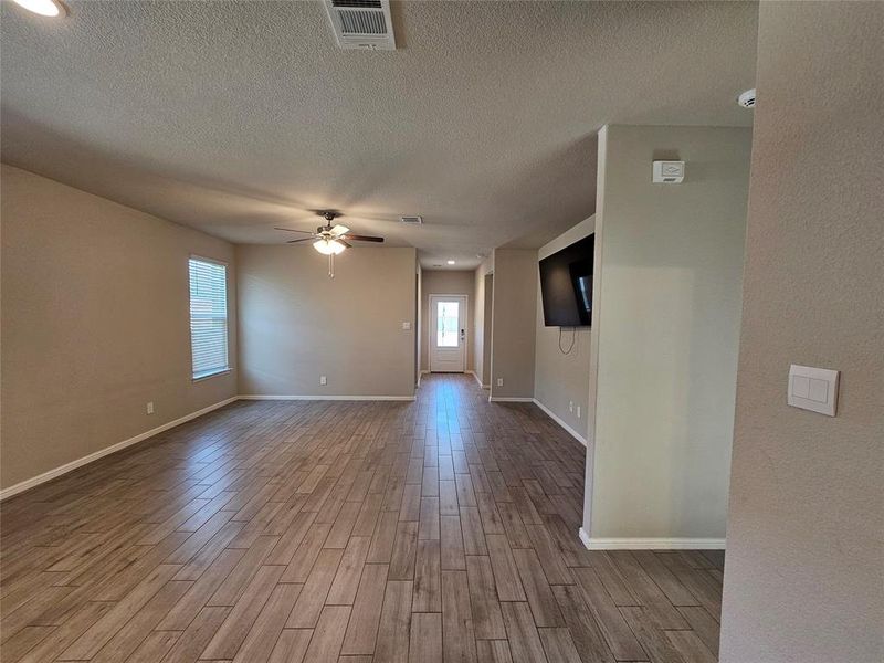 Entry and living room area featuring wood looking tile tile floors.