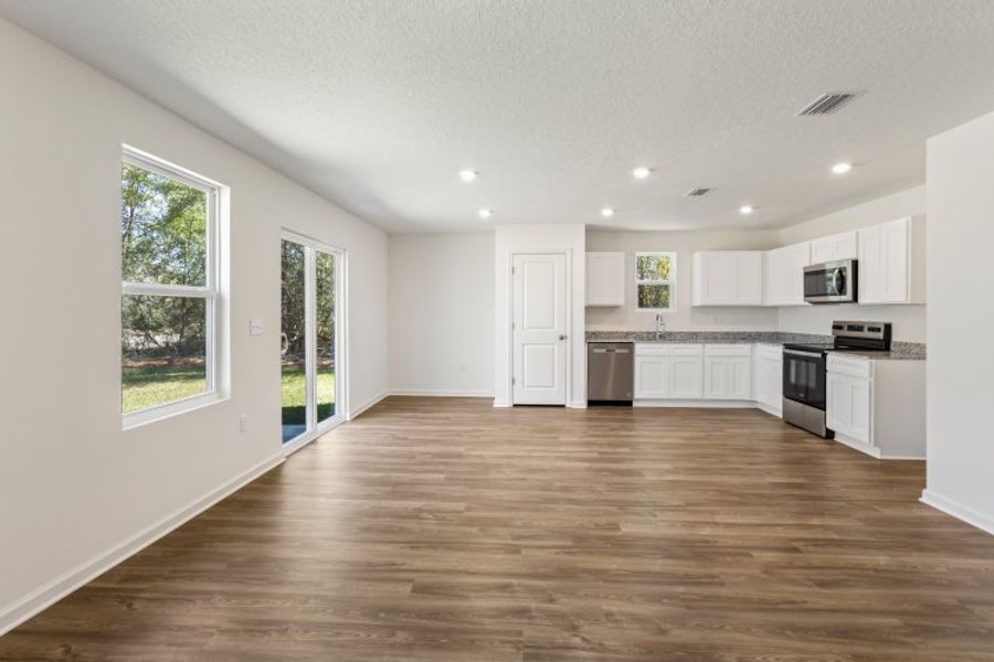 A large kitchen with white cabinets. A large kitchen with white cabinets.