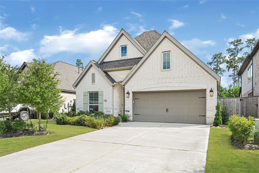 Front exterior of a new home in Grand Central Park 45', Conroe, TX, highlighting curb appeal (Image 20). Front exterior of a new home in Grand Central Park 45', Conroe, TX, highlighting curb appeal (Image 20).