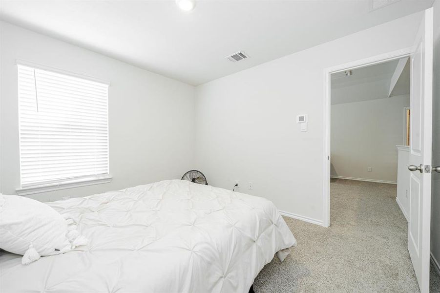 Bedroom featuring light carpet Bedroom featuring light carpet
