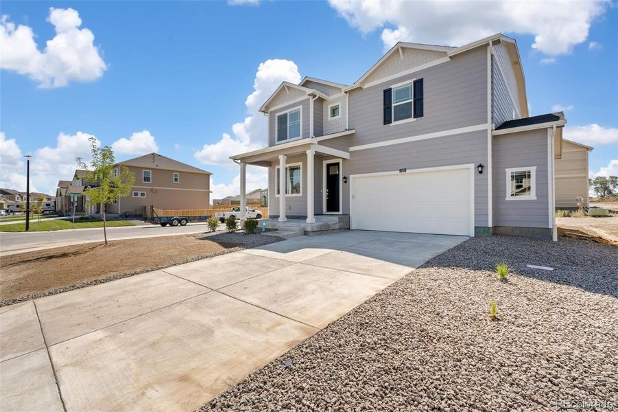 Front exterior of a new home in Trails at Crowfoot, Parker, CO, highlighting curb appeal (Image 17).