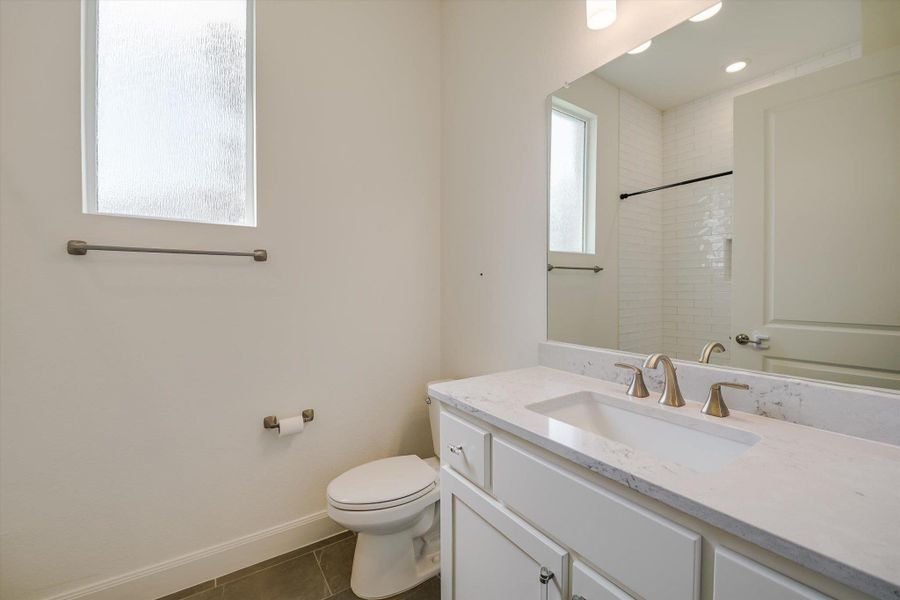 Full bathroom with vanity, tile patterned floors, and a shower Full bathroom with vanity, tile patterned floors, and a shower