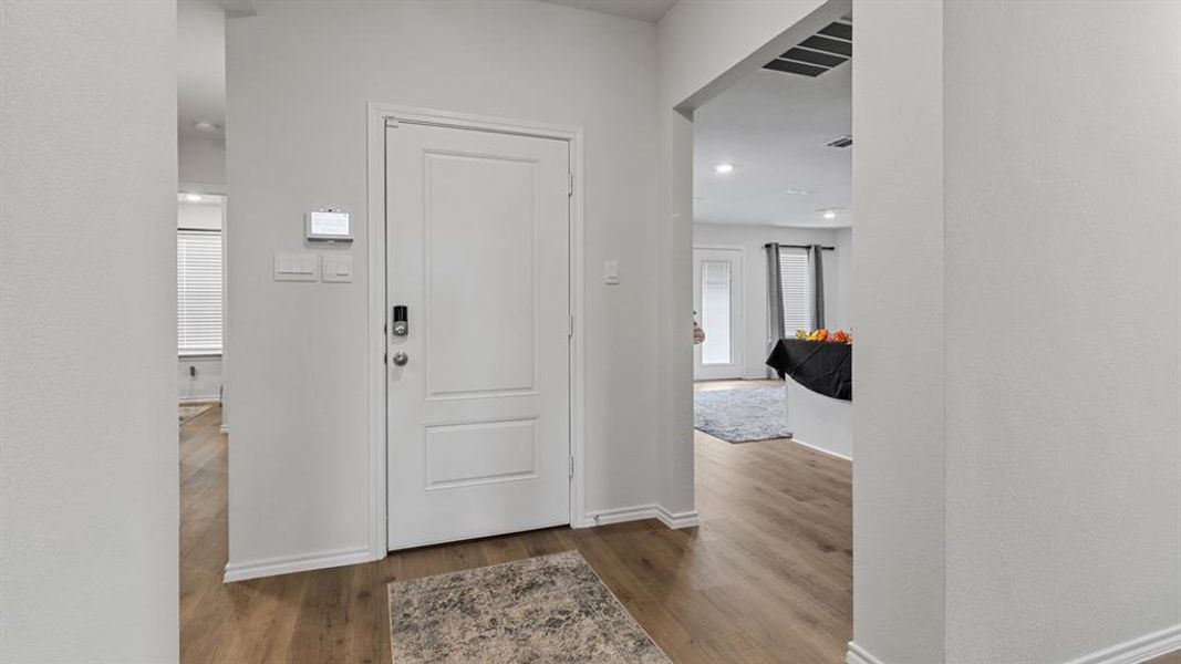 Entrance foyer with dark wood-type flooring and recessed lighting Entrance foyer with dark wood-type flooring and recessed lighting