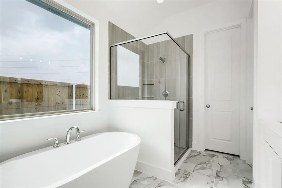Freestanding soaking tub with chrome fixtures