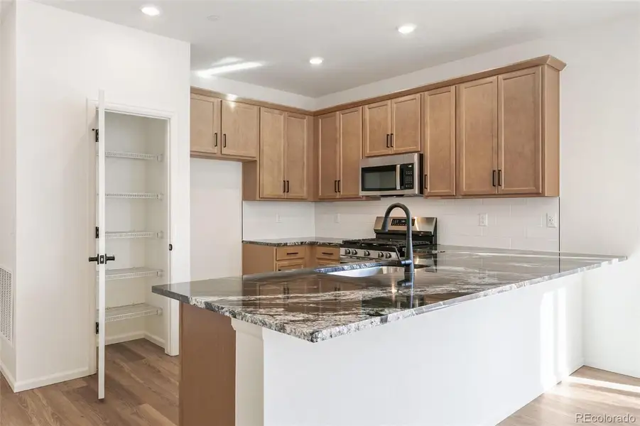 Furnished interior view inside a new home in Turnberry Villas, Commerce City (Image 6).