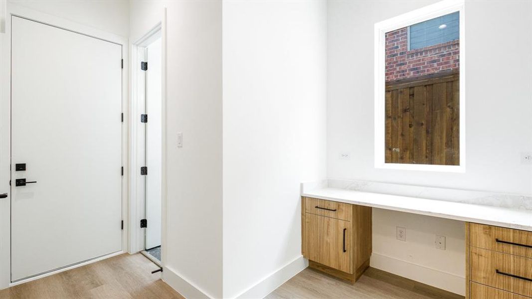 Corridor with light hardwood / wood-style flooring