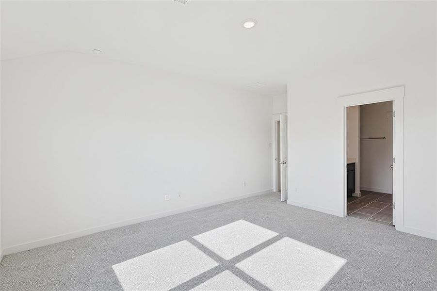 Unfurnished bedroom featuring carpet floors and ensuite bath