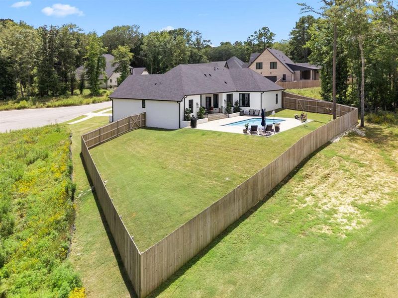 Rear view of property featuring a fenced backyard and a patio Rear view of property featuring a fenced backyard and a patio