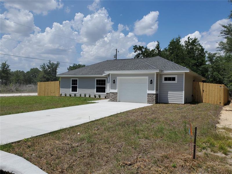 Front exterior of a new home in , Dunnellon, FL, highlighting curb appeal (Image 26).