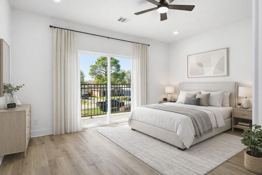 Upstairs, the primary bedroom offers a ceiling fan, a private balcony, and a spacious ensuite bathroom. (staged)