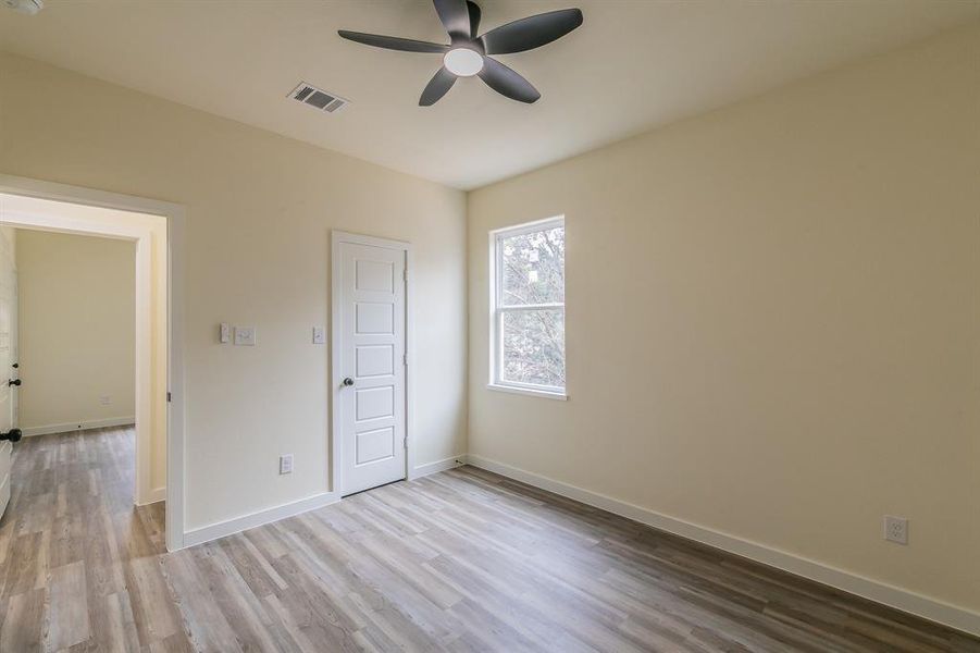 Unfurnished bedroom featuring light wood-type flooring and ceiling fan