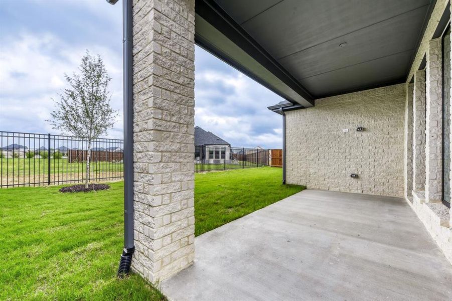 Fenced backyard with a patio area
