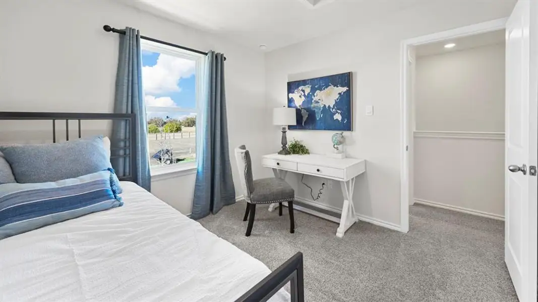 Bedroom featuring light carpet and baseboards
