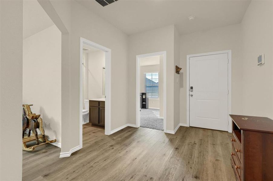 Foyer entrance with light hardwood / wood-style floors