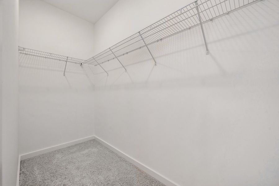 A white wall with a metal bar.