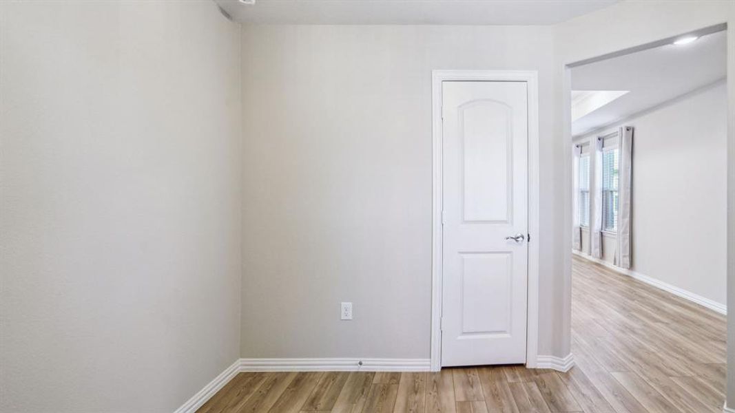 Spare room with light wood-type flooring and baseboards Spare room with light wood-type flooring and baseboards