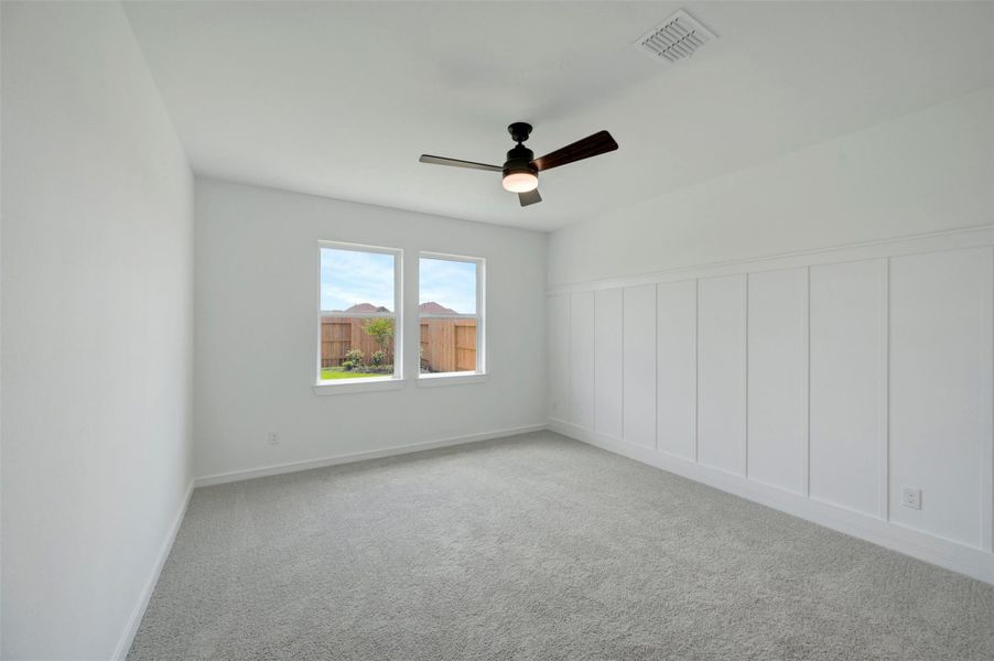 Private primary suite with decorative feature wall