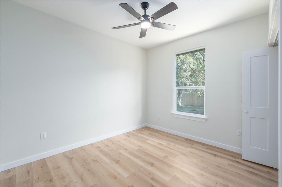 Spare room with light wood-type flooring and ceiling fan
