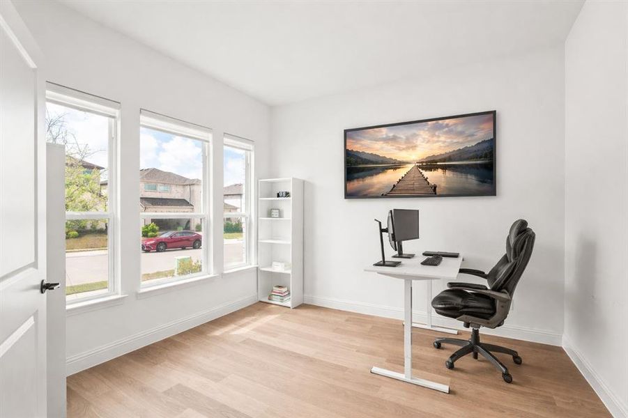 Office area featuring light wood finished floors and baseboards