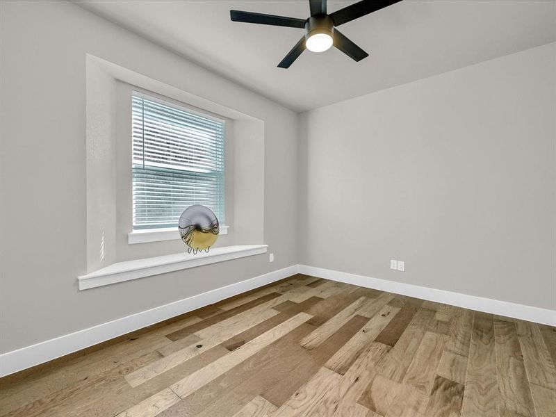 Unfurnished room with light wood-type flooring and ceiling fan Unfurnished room with light wood-type flooring and ceiling fan