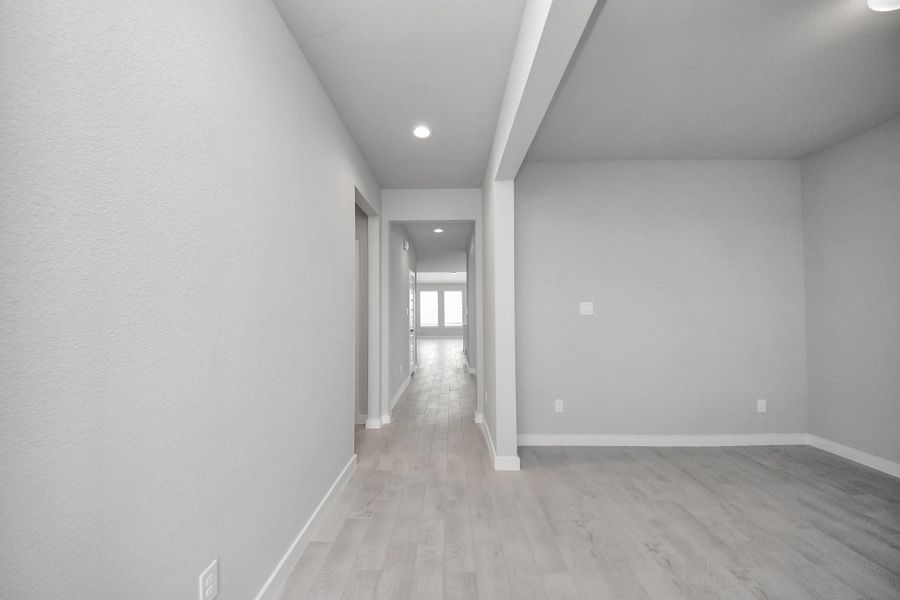 As you step into the threshold of this luxurious home, you'll soon be welcomed by an elegant glass door (to be installed). Inside, soaring ceilings amplify the spaciousness, while the refined wood-look tile flooring and oversized baseboards exude sophistication and charm. Sample photo of completed home with similar floor plan. Actual colors and selections may vary. As you step into the threshold of this luxurious home, you'll soon be welcomed by an elegant glass door (to be installed). Inside, soaring ceilings amplify the spaciousness, while the refined wood-look tile flooring and oversized baseboards exude sophistication and charm. Sample photo of completed home with similar floor plan. Actual colors and selections may vary.