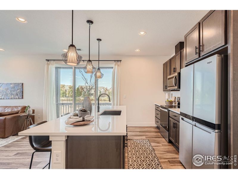 Light and bright, the kitchen opens to a West-facing balcony.