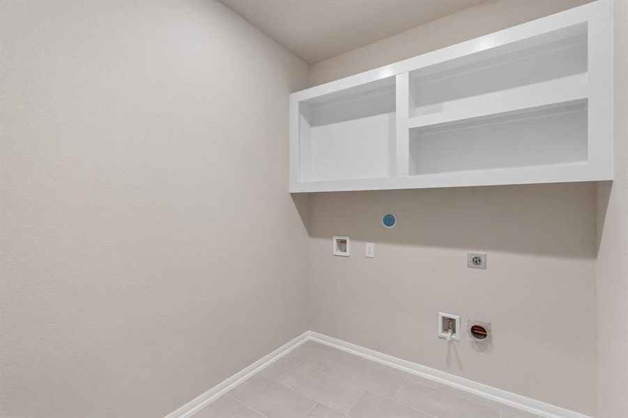 The laundry room layout is carefully planned for optimal workflow with designated areas for washing, drying, and storing.