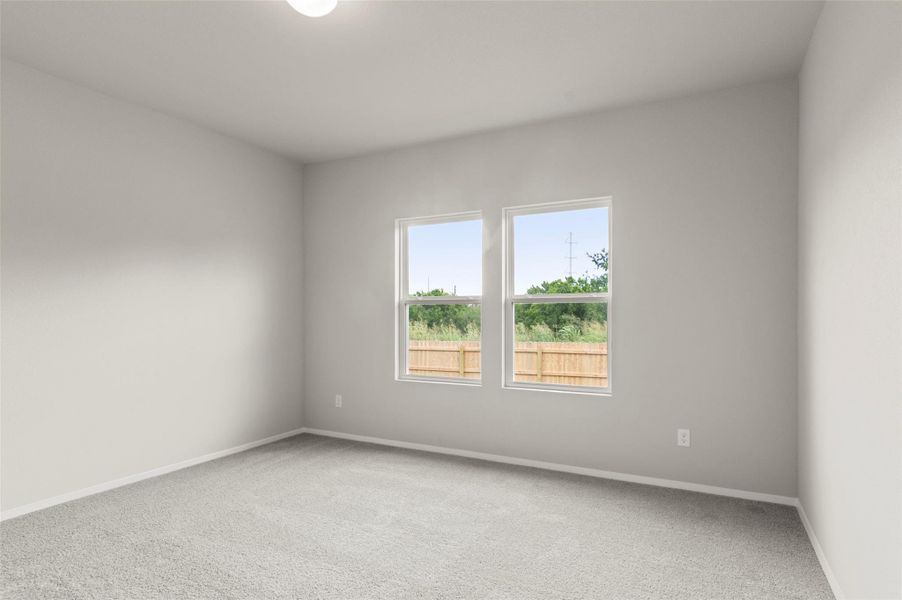 Carpeted spare room with baseboards
