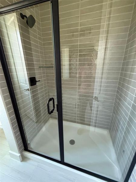 Bathroom featuring a shower stall Bathroom featuring a shower stall