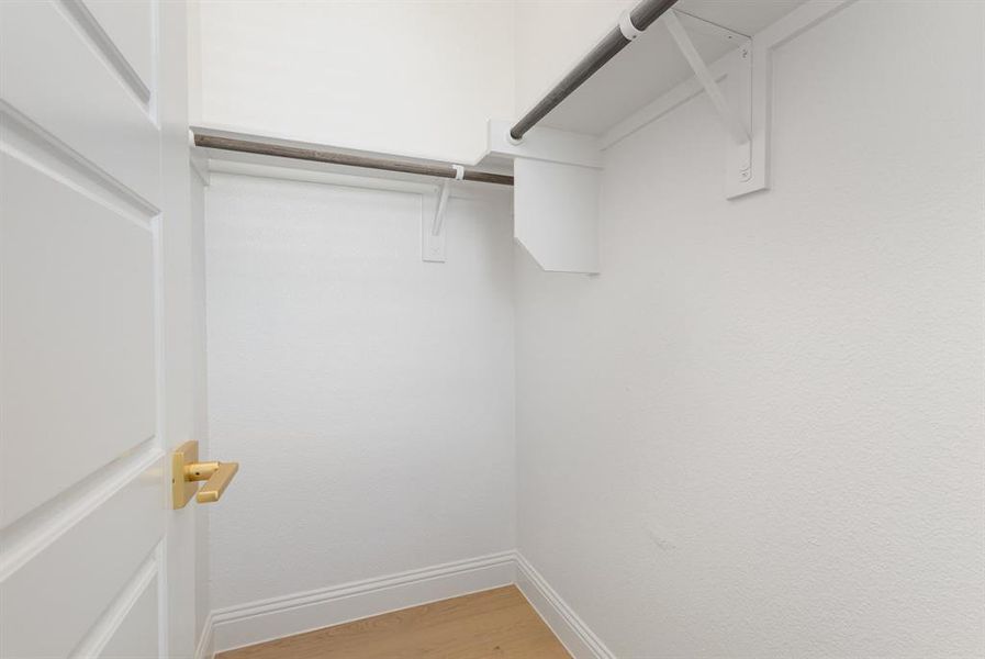 Spacious closet featuring light wood-type flooring