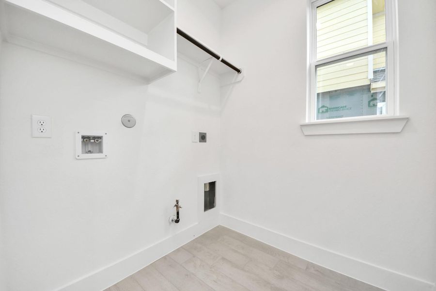 A perfect blend of functionality and comfort. Capture the essence of easy living with a first-floor laundry room, thoughtfully equipped with shelving for effortless organization. Both electric and gas connections available. A perfect blend of functionality and comfort. Capture the essence of easy living with a first-floor laundry room, thoughtfully equipped with shelving for effortless organization. Both electric and gas connections available.