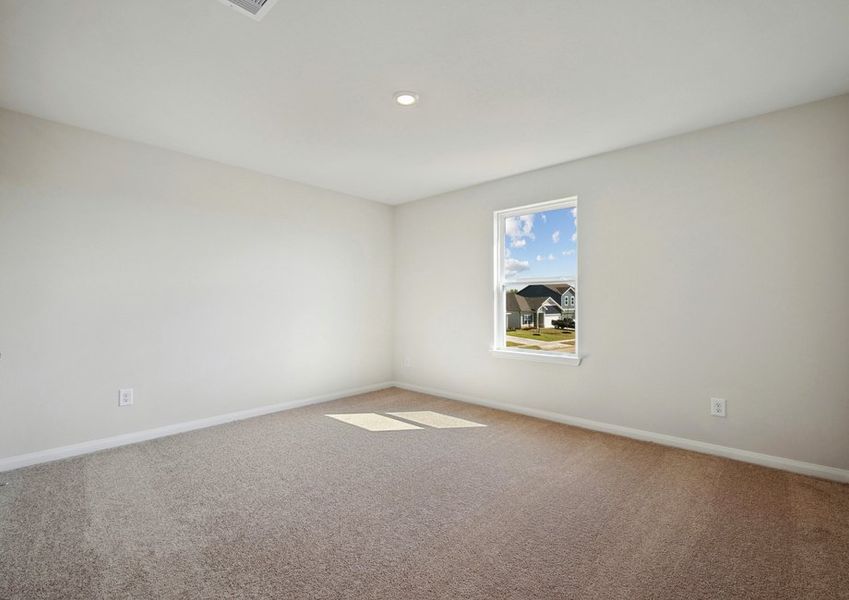Spacious upstairs bedroom with lush carpet