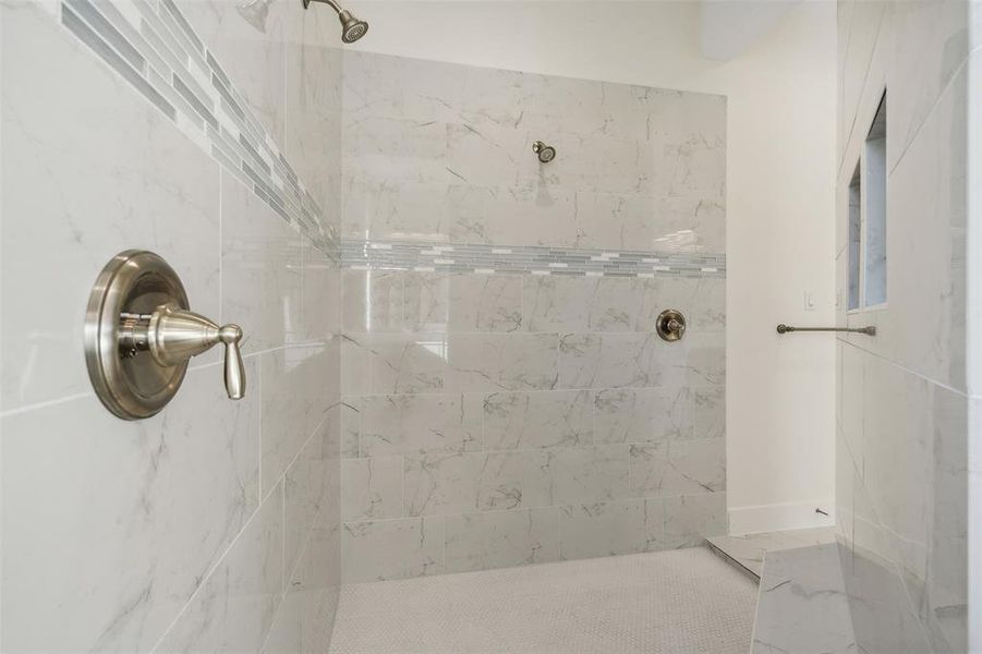 Bathroom featuring a tile shower