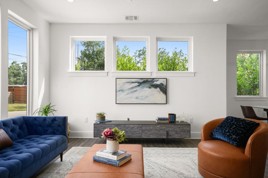 Natural light floods this inviting living space, highlighting clean lines and warm wood flooring. Natural light floods this inviting living space, highlighting clean lines and warm wood flooring.