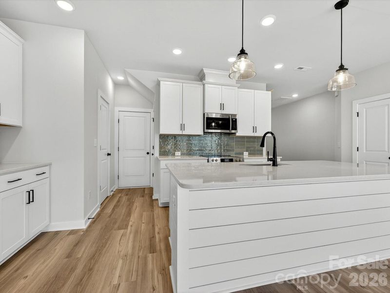 Primary bedroom features tray ceiling, 3 large windows allow the room to be flooded with natural light while allowing views of private wooded backyard.