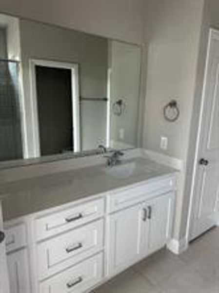 Bathroom with tile patterned floors and vanity