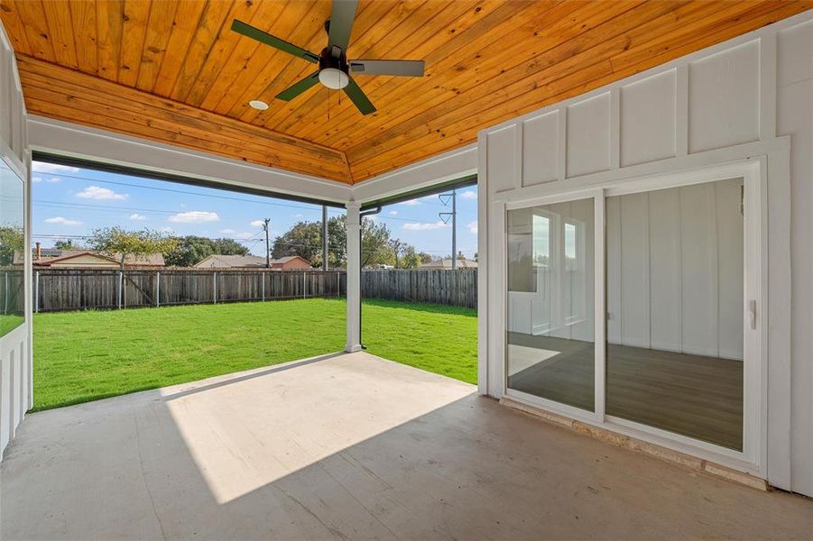Unfurnished sunroom featuring a ceiling fan and a patio area Unfurnished sunroom featuring a ceiling fan and a patio area