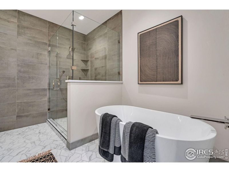 Gorgeous 5 piece primary bathroom with ceiling to floor tile shower and stand alone soaking tub