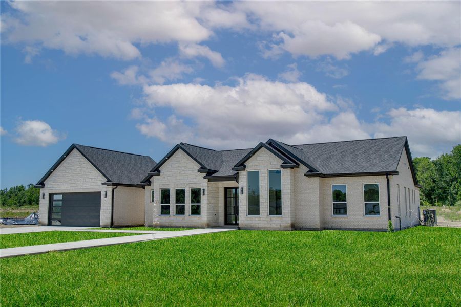 Front exterior of a new home in , Dayton, TX, highlighting curb appeal (Image 1).