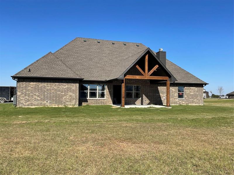 Rear view of property featuring a lawn