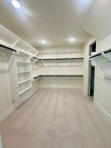 Ample shelving and hanging space defines this generously sized walk-in closet.