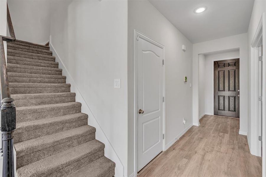 Stairway featuring light hardwood / wood-style floors