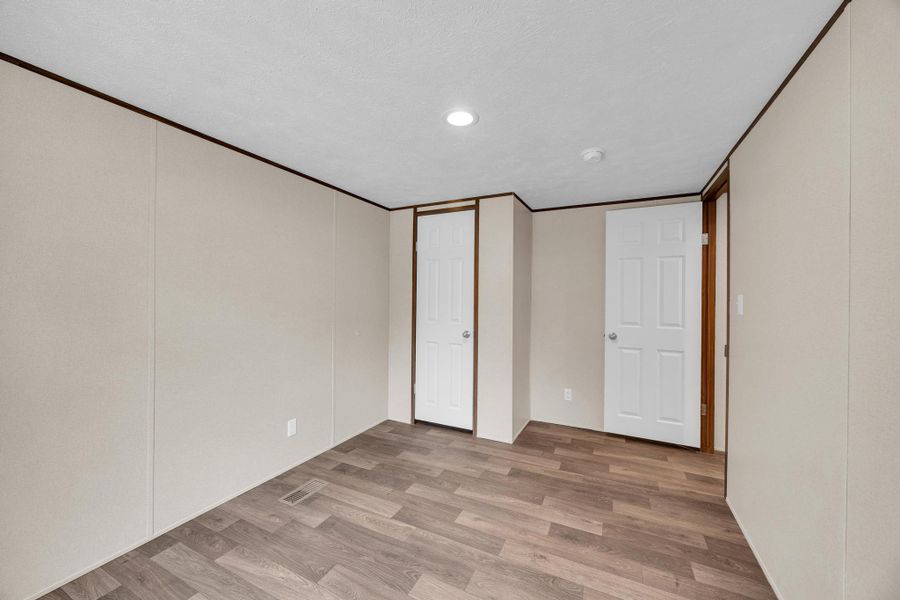 Unfurnished bedroom with light wood-style floors and recessed lighting