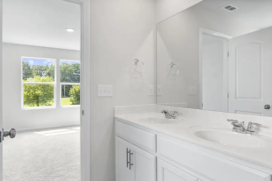 A bathroom with white cabinets. A bathroom with white cabinets.