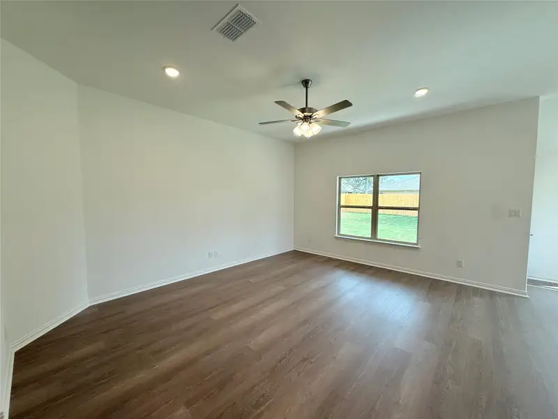 Empty room featuring dark wood finished floors, recessed lighting, and ceiling fan Empty room featuring dark wood finished floors, recessed lighting, and ceiling fan
