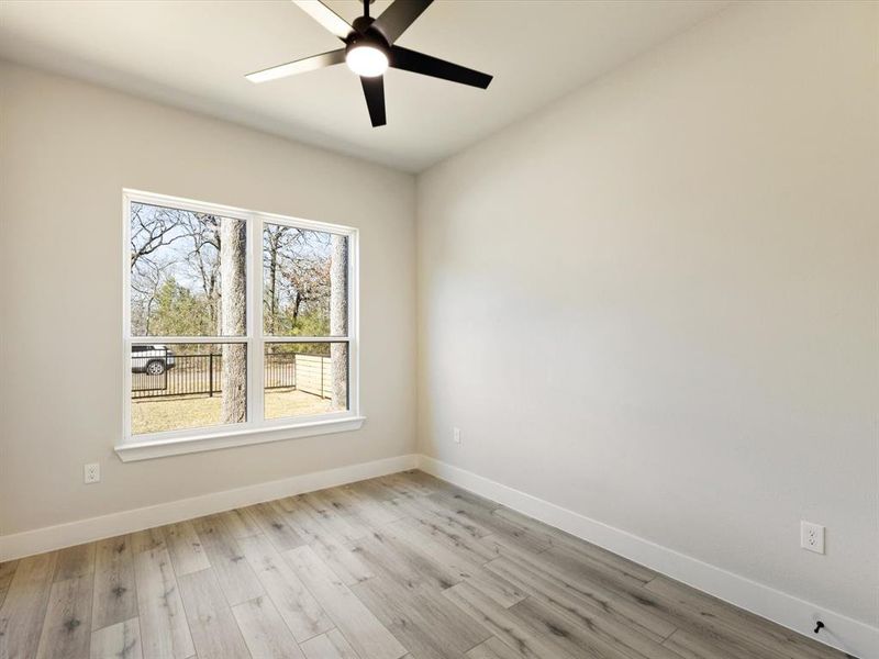Spare room featuring light wood-type flooring and ceiling fan