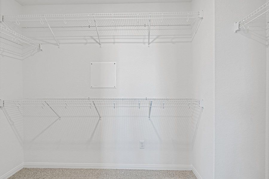 Ample wire shelving lines this functional walk-in closet space.