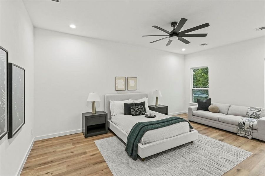 Bedroom featuring light hardwood / wood-style floors and ceiling fan